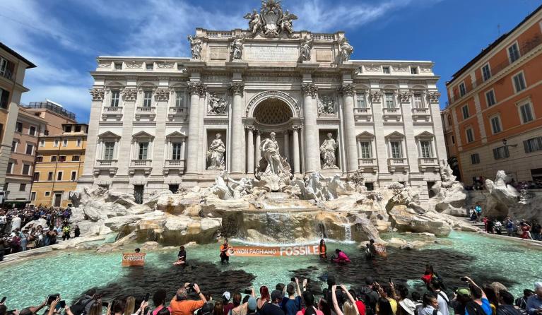 Climate activists from the group 'Last Generation' stand inside the Trevi Fountain in Rome, Italy, 21 May 2023. About a dozen activists, who recalled the emergency in the Italian region of Emilia-Romagna, where about 30,000 people have been displaced after heavy floods in recent days, threw a black liquid, vegetable charcoal, into the famed Trevi fountain with banners reading 'let's not pay for fossils' and shouting 'our country is dying'. Local police intervened on the spot. EPA/GIULIA MARRAZZO