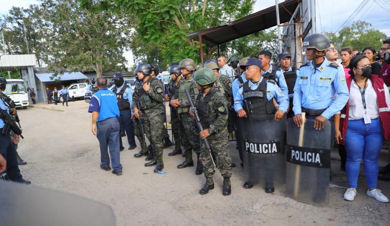 Police and military guard the prison where at least 41 people died and another seven were injured in a brawl and a fire registered at the Women's Center for Social Adaptation (Cefas) near the Honduran capital in Tegucigalpa, Honduras, 20 June 2023. The spokesman for the Public Ministry, Yuri Mora, confirmed to journalists that '41 inmates have died so far, most of them from burns' but the final figure will not be known until the removal of the bodies is completed. The president of the Association of Relativ
