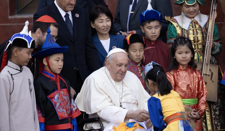 Pope Francis (C) greets a child as he attends a welcoming ceremony at the Apostolic Nunciature to Mongolia in Ulaanbaatar on September 1, 2023. Anand TUMURTOGOO / AFP