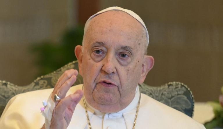 This handout photograph taken and released by the Vatican press office on November 26, 2023, shows Pope Francis (R) reciting the Angelus Prayer flanked by Mons. Paolo Braida (L) in his residence at the Vatican. Pope Francis will recite Sunday's Angelus prayer from his residence rather than overlooking St Peter's Square as he deals with a mild bout of flu, the Vatican press service said. The Argentinian pontiff, 86, on November 25, 2023 had a CT scan which ruled out any pulmonary complications and cancelled 