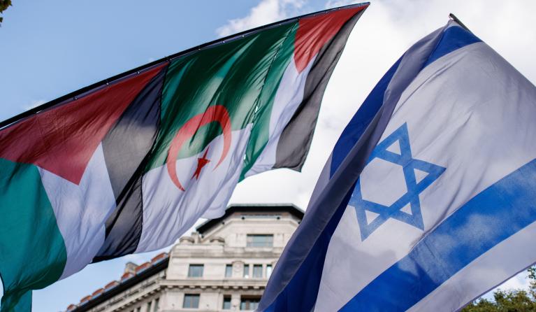 Flags of pro-Palestinian and counter pro-Israeli demonstrators are seen together during a march to Downing Street to mark one year of the Israeli operations in the Gaza Strip and to call for a permanent ceasefire as part of an event organised by the Palestine Solidarity Campaign in London, Britain, 05 October 2024.