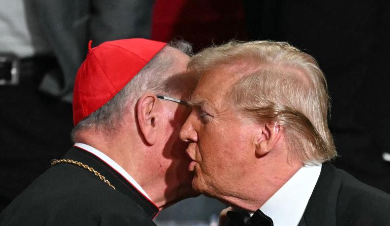 Former US President and Republican presidential candidate Donald Trump (R) chats with Archbishop of New York Timothy M. Dolan during the 79th Annual Alfred E. Smith Memorial Foundation Dinner at the Hilton Midtown in New York, October 17, 2024. TIMOTHY A. CLARY / AFP