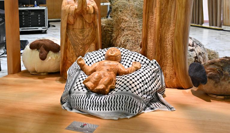 This photograph shows the "Christ Child" displayed on a keffiyeh scarf gifted by the Palestinian Higher Committee of Churches Affairs, as part of the "Nativity of Bethlehem 2024" during its inauguration in the Paul VI Hall, during the private audience to donors of the Nativity Scene and the lighting of the Christmas tree ceremony at St Peter’s Square in the Paul-VI hall at the Vatican on December 7, 2024. Andreas SOLARO / AFP