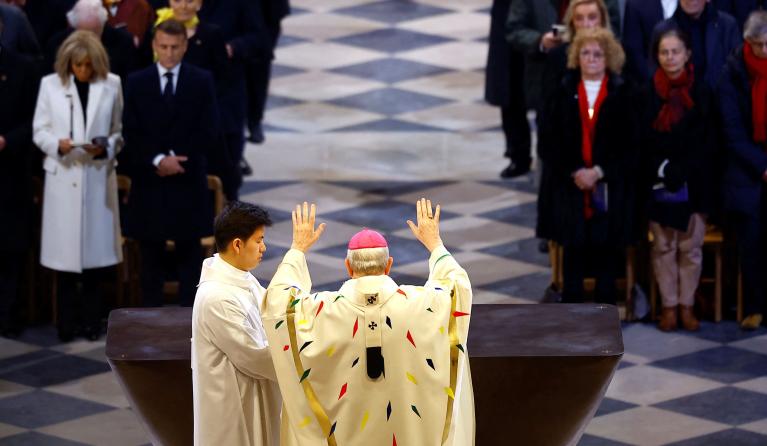 Paris' Archbishop Laurent Ulrich blesses the altar as French President Emmanuel Macron and his wife Brigitte Macron look on during the inaugural Mass at the Notre-Dame de Paris Cathedral in Paris, France, 08 December 2024. The Notre Dame de Paris Cathedral reopened on 07 December after nearly six years of renovation work following its destruction by a fire on 15 April 2019. EPA