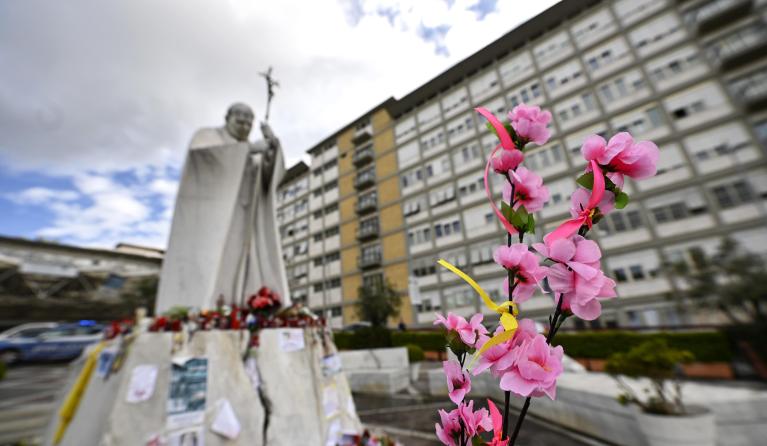 Flowers left by faithful in front of the statue of John Paul II at the entrance of Gemelli Hospital where Pope Francis is still hospitalized, Rome, Italy, 13 March 2025. EPA/RICCARDO ANTIMIANI