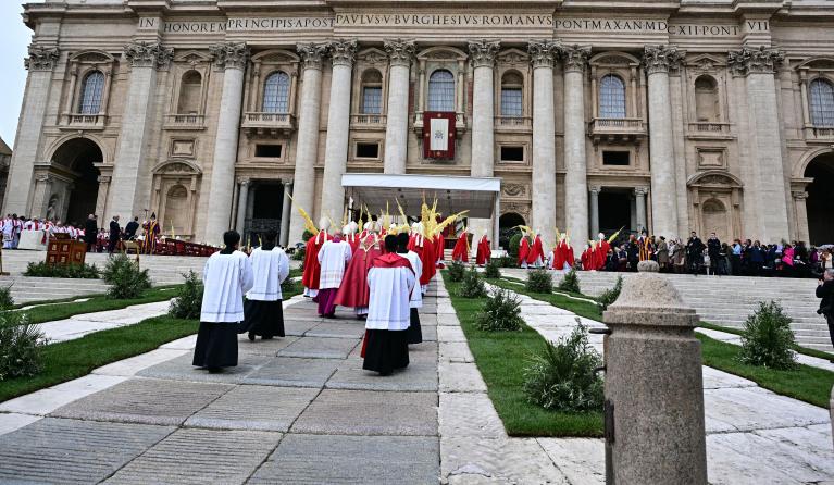 Celebrants and cardinals walk in procession during a mass for Palm Sunday in St Peter's square in the Vatican on April 13, 2025. Tiziana FABI / AFP