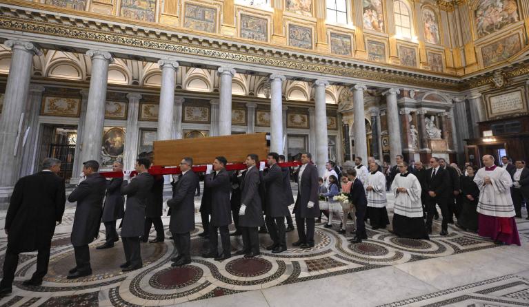 This photo taken and released on April 26, 2025, by The Vatican Media shows pallbearers carrying the coffin of late Pope Francis at the end of his funeral service, inside Santa Maria Maggiore Basilica, the Pope's final resting place, in Rome. Pope Francis was buried inside his favourite Rome church after a funeral mass in St Peter's Square, the Vatican said on April 26, 2025.  Handout / VATICAN MEDIA 