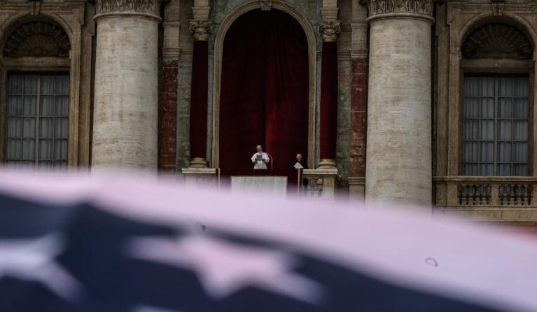 A US flag is waved as Pope Leo XIV delivers the Regina Caeli prayer from the main central loggia of St Peter's basilica in The Vatican, on May 11, 2025. JEFF PACHOUD / AFP