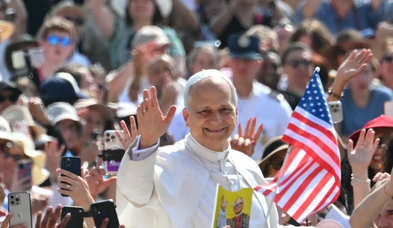 Pope Leo XIV waves to the crowd during the weekly general audience at St Peter's Square in The Vatican on June 18, 2025. Andreas SOLARO / AFP
