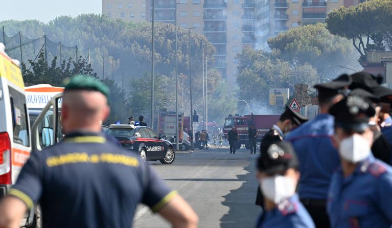 Firemen, policemen and rescue teams work on the site of an explosion in a fuel station in Rome on July 4, 2025. At least ten people were injured in an explosion with the blast heard across the Italian capital. Neighbouring buildings were evacuated following the explosion, which occurred shortly after 8am during what media reports said was a refueling operation.  Andreas SOLARO / AFP