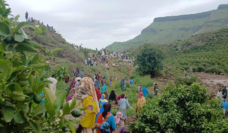 This handout image made available by the Sudan Liberation Movement/Army (SLM), on September 1, 2025, shows people inspecting the debris after a landslide devastated the village of Tarasin in Sudan's Jebel Marra area. A massive landslide in Sudan's western Darfur region has flattened an entire mountain village and killed more than 1,000 people, the Sudan Liberation Movement/Army (SLM) group said, leaving only one survivor. SUDAN LIBERATION MOVEMENT/ARMY / AFP