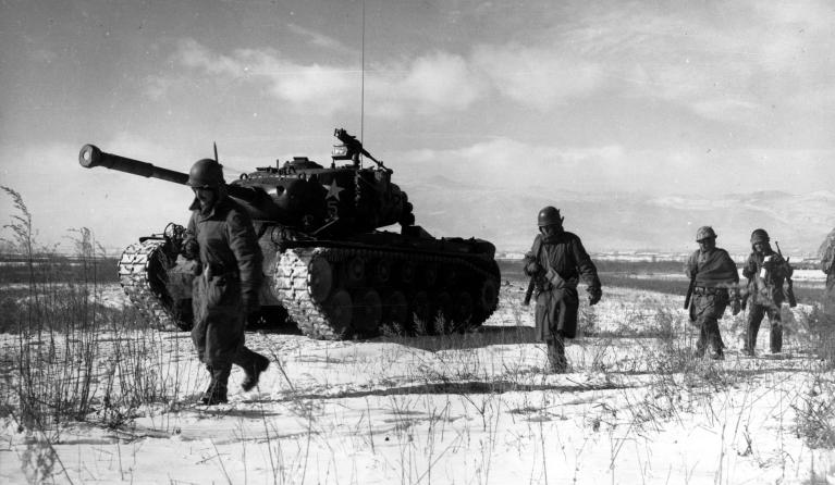 A column of troops and armor of the 1st Marine Division move through communist Chinese lines during their successful breakout from the Chosin Reservoir in North Korea. The Marines were besieged when the Chinese entered the Korean War November 27, 1950, by sending 200,000 shock troops against Allied forces.