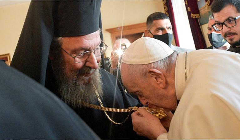 This photo handout released by The Vatican Media shows Pope Francis (R) kissing the cross of Chrysostomos II, the Greek Orthodox Archbishop of Cyprus, at the Archbishopric in the Old City of Nicosia, Europe's last divided capital, on December 3, 2021.