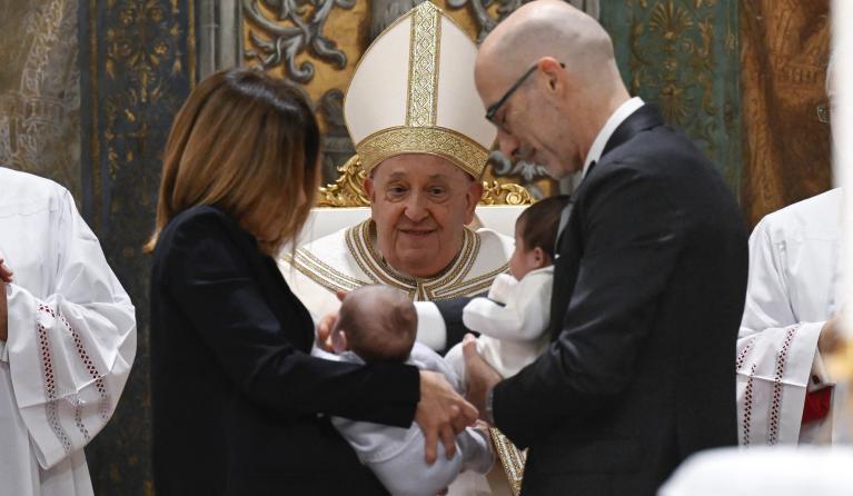This handout photo taken and released on January 7, 2024, by the Vatican Media, shows Pope Francis baptising infants during celebrations for the Feast of the Baptism of the Lord, in the Sistine Chapel at the Vatican. Simone Risoluti / VATICAN MEDIA / AFP