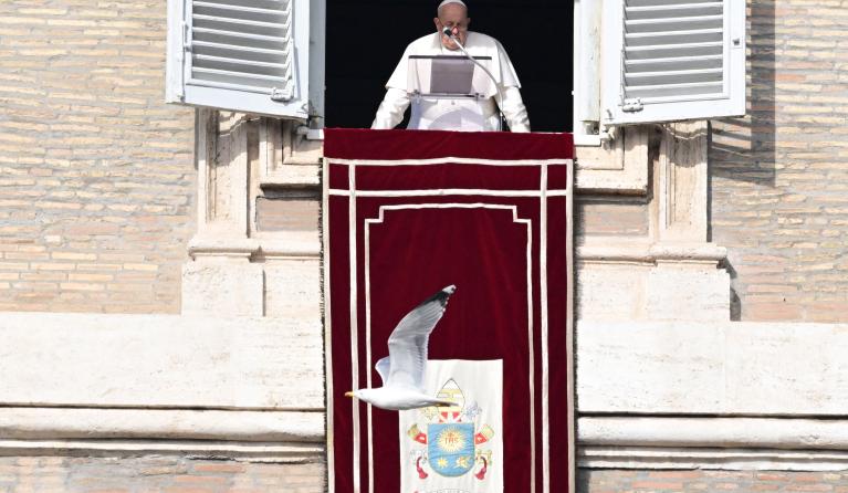 Pope Francis addresses the crowd from the window of the apostolic palace overlooking St. Peter's square during the Angelus prayer on January 14, 2024 in The Vatican. Tiziana FABI / AFP