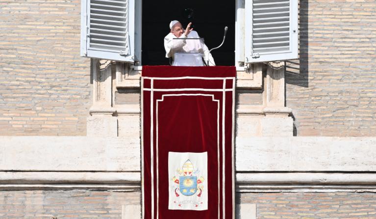 Pope Francis waves from the window of the apostolic palace overlooking St. Peter's square during the Angelus prayer on January 28, 2024 in The Vatican. Alberto PIZZOLI / AFP