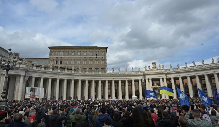 Pope Francis (C-UP) waves to the crowd, from the window of the Apostolic Palace overlooking St. Peter's Square, during the weekly Angelus prayer in The Vatican on March 3, 2024. Andreas SOLARO / AFP