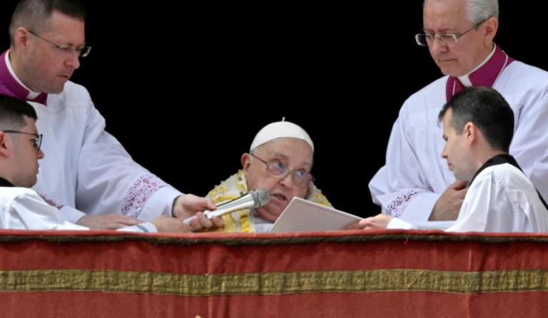 Pope Francis addresses the crowd from the main balcony of St. Peter's basilica for the Urbi et Orbi message and blessing to the city and the world as part of Easter celebrations, at St Peter's square in the Vatican on April 20, 2025. Andreas SOLARO / AFP