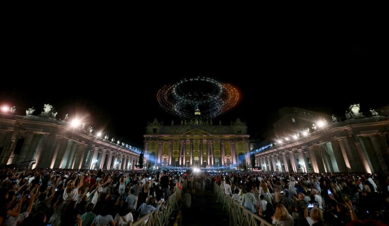 Illuminated drones create figures during "Grace for the World" free concert and light show in Saint Peter's Square at the Vatican on September 13, 2025. "Grace for the World" concert is co-directed by American songwriter Pharrell Williams and Italian tenor Andrea Bocelli. The event marks the end of the third "World Meeting on Human Fraternity", a series of encounters launched after the 2020 publication of the "All Brothers" encyclical by the late pope Francis. Filippo MONTEFORTE / AFP