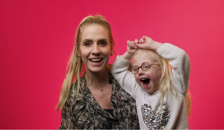 Romy en Amelle voor een roze achtergrond in Burgerzaken