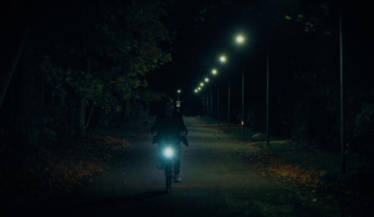 Een man op een fiets in het donker