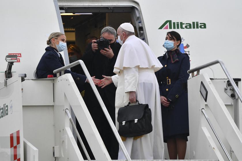 Pope Francis is welcomed by an hostess as he boards a plane to depart to Iraq on March 5, 2021 at Rome's Fiumicino airport. AFP Pope Francis is welcomed by an hostess as he boards a plane to depart to Iraq on March 5, 2021 at Rome's Fiumicino airport. AFP