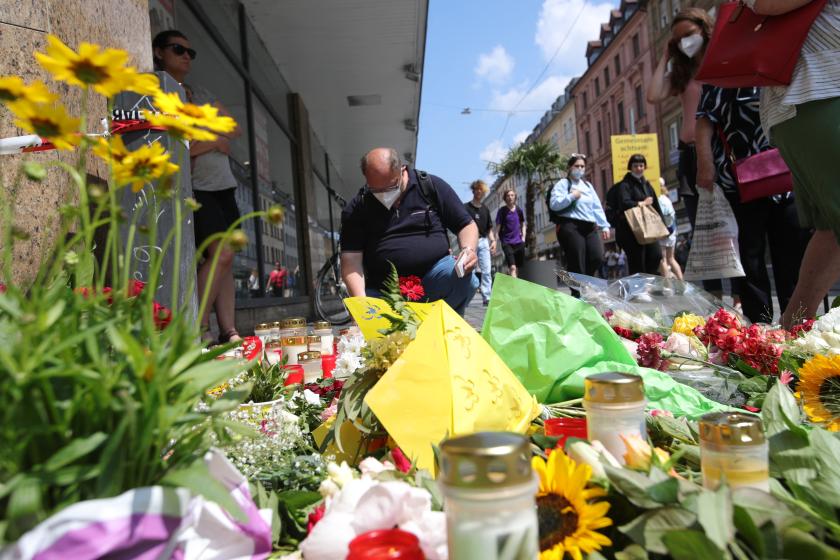 People place flowers and candles at a makeshift memorial in tribute to the victims of a deadly attack in the city center of Wuerzburg, southern Germany, on June 26, 2021. Investigators were racing to pinpoint the motive of a man who went on a knife rampage in the German city of Wuerzburg, killing three people and leaving five seriously injured. The suspect, a 24-year-old Somali who arrived in Wuerzburg in 2015, staged the attack in the city centre on the evening of Friday, June 25, 2021, striking at a household goods store before advancing to a bank. ARMANDO BABANI / AFP People place flowers and candles at a makeshift memorial in tribute to the victims of a deadly attack in the city center of Wuerzburg, southern Germany, on June 26, 2021. Investigators were racing to pinpoint the motive of a man who went on a knife rampage in the German city of Wuerzburg, killing three people and leaving five seriously injured. The suspect, a 24-year-old Somali who arrived in Wuerzburg in 2015, staged the attack in the city centre on the evening of Friday, June 25, 2021, striking at a house