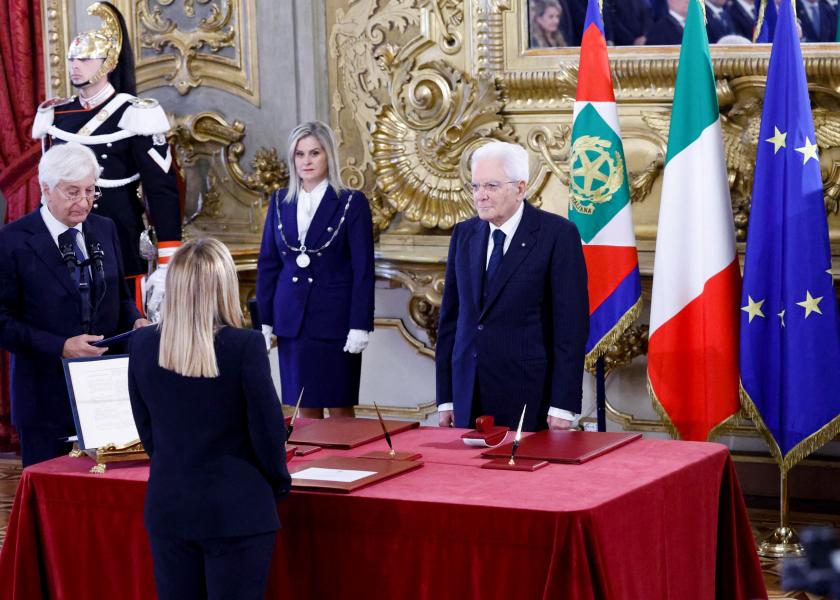 Italian President Sergio Mattarella (R) greets new Prime Minister Giorgia Meloni (front) as she arrives for the swearing-in ceremony of the new Italian Government at the Quirinal Palace in Rome on October 22, 2022.  FABIO FRUSTACI / ANSA / AFP