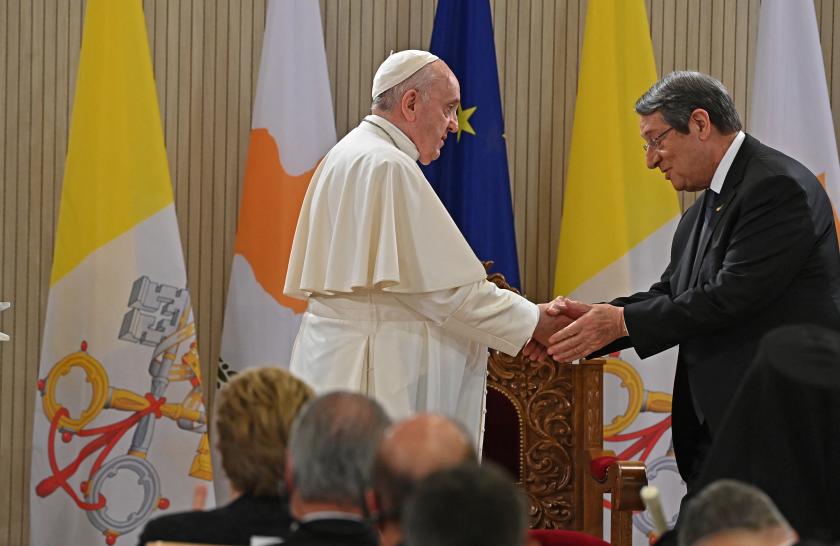 Pope Francis shakes hands with Cyprus' President Nicos Anastasiades during the pontiff's welcome ceremony at the Presidential Palace in Cyprus' capital Nicosia on December 2, 2021. ANDREAS SOLARO / AFP Pope Francis shakes hands with Cyprus' President Nicos Anastasiades during the pontiff's welcome ceremony at the Presidential Palace in Cyprus' capital Nicosia on December 2, 2021.