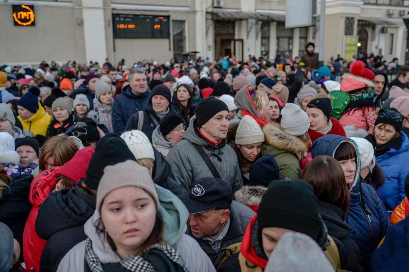 People gather on a platform to evacuate the city on March 9, 2022 at the central train station of the major port city of Odessa which remains under Ukrainian control and has so far been spared fighting, but the US Defense Department said Russian ground forces appeared primed to attack the city, possibly in coordination with an amphibious assault.