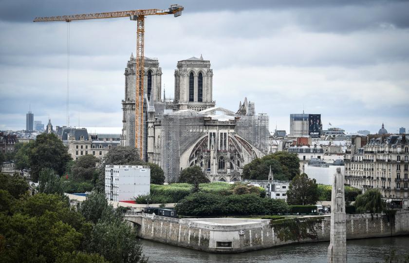 This photograph taken on August 19, 2021 in Paris, shows a giant crane outside Notre-Dame Cathedral, which was partially destroyed when fire broke out beneath the roof on April 15, 2019. STEPHANE DE SAKUTIN / AFP This photograph taken on August 19, 2021 in Paris, shows a giant crane outside Notre-Dame Cathedral, which was partially destroyed when fire broke out beneath the roof on April 15, 2019.