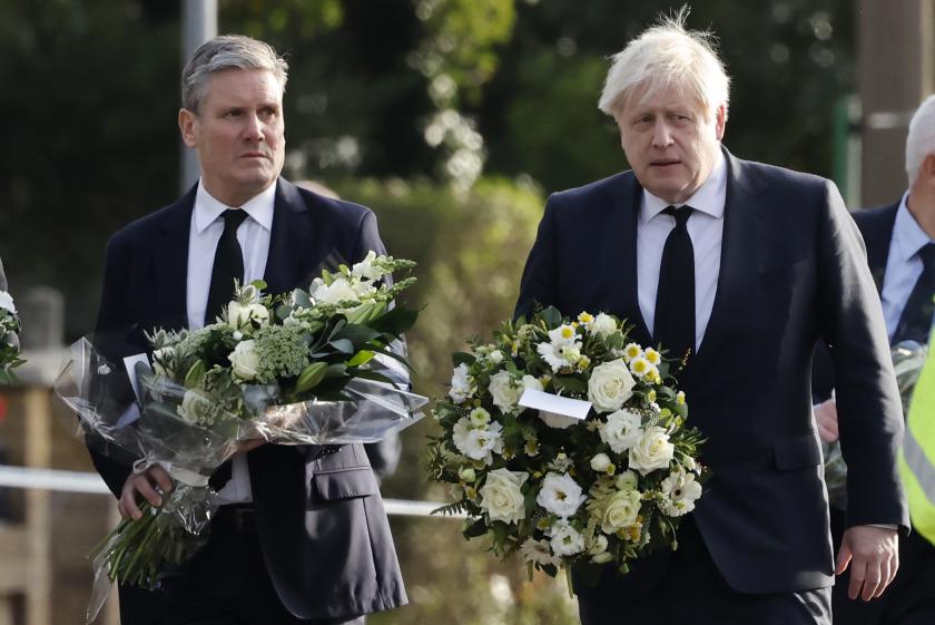 Britain's Prime Minister Boris Johnson (R) and Britain's main opposition Labour Party leader Keir Starmer carry floral tributes as they arrivre at the scene of the fatal stabbing of Conservative British lawmaker David Amess, at Belfairs Methodist Church in Leigh-on-Sea, a district of Southend-on-Sea, in southeast England on October 16, 2021. Conservative British lawmaker David Amess was killed on Friday after being stabbed "multiple times" during an event in his local constituency in southeast England, in the second death of a UK politician while meeting voters since 2016. Local police did not name Amess but said a man had been arrested "on suspicion (of) murder" after the stabbing in Leigh-on-Sea. Britain's Prime Minister Boris Johnson (R) and Britain's main opposition Labour Party leader Keir Starmer carry floral tributes as they arrivre at the scene of the fatal stabbing of Conservative British lawmaker David Amess, at Belfairs Methodist Church in Leigh-on-Sea, a district of Southend-on-Sea, in southeast England on October 16, 2021. Conservative British lawmaker David Amess was killed on Friday after being stabbed "multiple times" during an event in his local constituency in southeast England, in t
