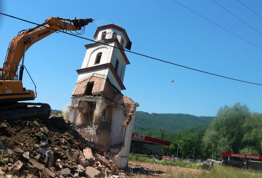 A digger demolishes an illegally constructed Serbian Orthodox church in Konjevic Polje, Eastern Bosnia on June 5, 2021, which was built in 1998 on land near Srebrenica, seized from Fata Orlovic, a Muslim refugee after the 1992-1995 civil war. The demolition began more than a year and a half after the European Court of Human Rights (ECHR) ordered the destruction of the church, which had been built on land owned by Muslims forced to flee during the war. STR / AFP A digger demolishes an illegally constructed Serbian Orthodox church in Konjevic Polje, Eastern Bosnia on June 5, 2021, which was built in 1998 on land near Srebrenica, seized from Fata Orlovic, a Muslim refugee after the 1992-1995 civil war. The demolition began more than a year and a half after the European Court of Human Rights (ECHR) ordered the destruction of the church, which had been built on land owned by Muslims forced to flee during the war. STR / AFP