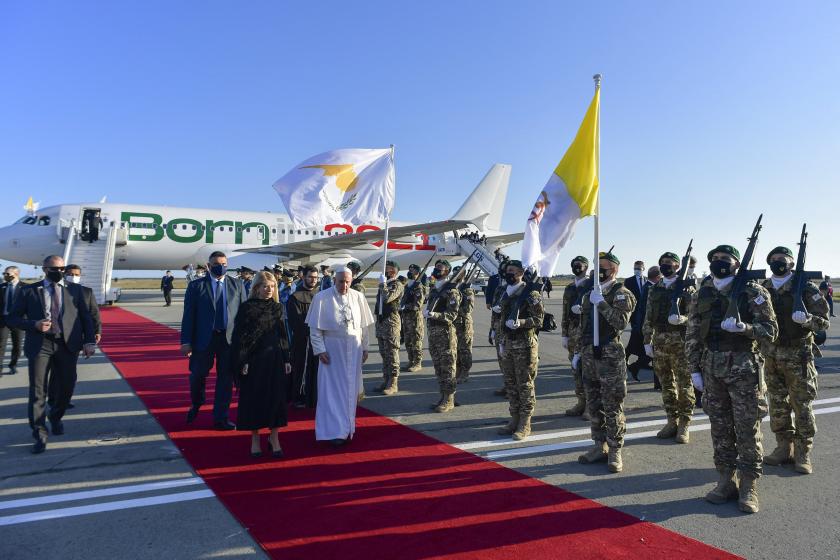 Pope Francis (C) welcomed by Cypriot Parliament Speaker Annita Demetriou (C-L) upon his arrival in the southern port city of Larnaca on December 2, 2021 at the start of a landmark trip. Handout / VATICAN MEDIA / AFP Pope Francis (C) welcomed by Cypriot Parliament Speaker Annita Demetriou (C-L) upon his arrival in the southern port city of Larnaca on December 2, 2021 at the start of a landmark trip. Handout / VATICAN MEDIA / AFP