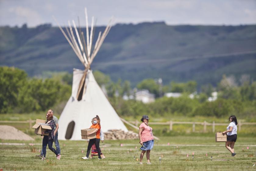 Members of the community arrive with solar lights to place next to the flags which mark the spots where remains were discovered by ground penetrating radar at the site of the former Marieval Indian Residential School on the Cowessess First Nation in Saskatchewan, Canada, on June 26, 2021. More than 750 unmarked graves have been found near a former Catholic boarding school for indigenous children in western Canada, a tribal leader said Thursday -- the second such shock discovery in less than a month. Geoff Robins / AFP Members of the community arrive with solar lights to place next to the flags which mark the spots where remains were discovered by ground penetrating radar at the site of the former Marieval Indian Residential School on the Cowessess First Nation in Saskatchewan, Canada, on June 26, 2021. More than 750 unmarked graves have been found near a former Catholic boarding school for indigenous children in western Canada, a tribal leader said Thursday -- the second such shock discovery in less than a month. Geoff R