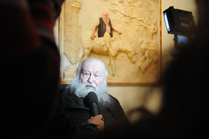 Austrian artist Herman Nitsch (R) of TEAM[:]niel poses by an image of himself superimposed on an erotic fresco at the Casoria Contemporary Art Museum (CAM) near Naples on November 28, 2013 at the opening of the ErotiCAM_Secret Room II exhibition, censored by the Italian culture ministry. The exhibition was conceived by TEAM[:]niel, an Austrian artist collective comprising Claudia Feyer, Daniel Feyer and Veronika Bayer to substitute photos of models in copies of the erotic frescoes from Pompeii. The audience