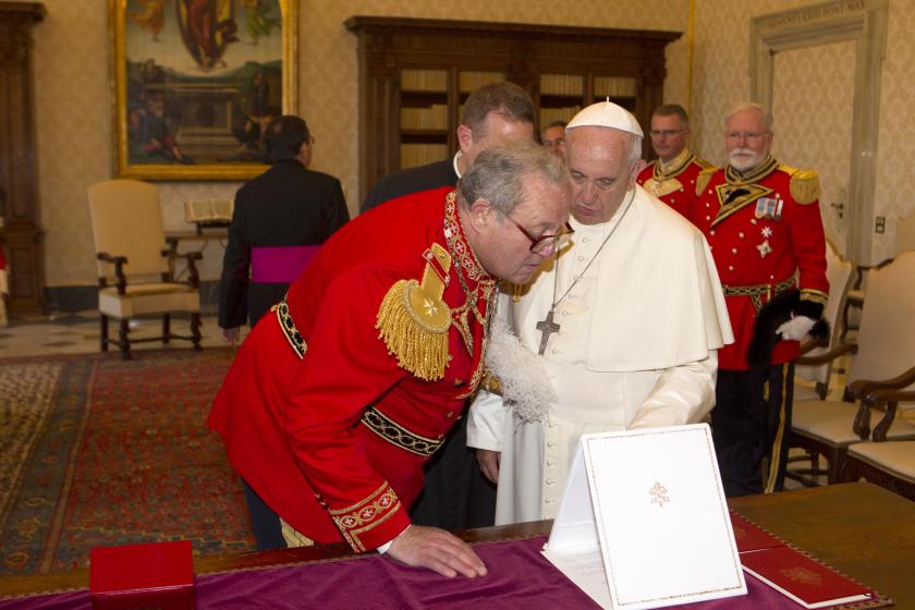Pope Francis (R) exchanges gifts with the 79th Prince and Grand Master of the Sovereign Military Order of Malta, Fra' Matthew Festing, during a private audience in the pontiff's library at the Vatican, on June 25, 2015. AFP PHOTO / POOL / RICCARDO DE LUCA Pope Francis (R) exchanges gifts with the 79th Prince and Grand Master of the Sovereign Military Order of Malta, Fra' Matthew Festing, during a private audience in the pontiff's library at the Vatican, on June 25, 2015. AFP