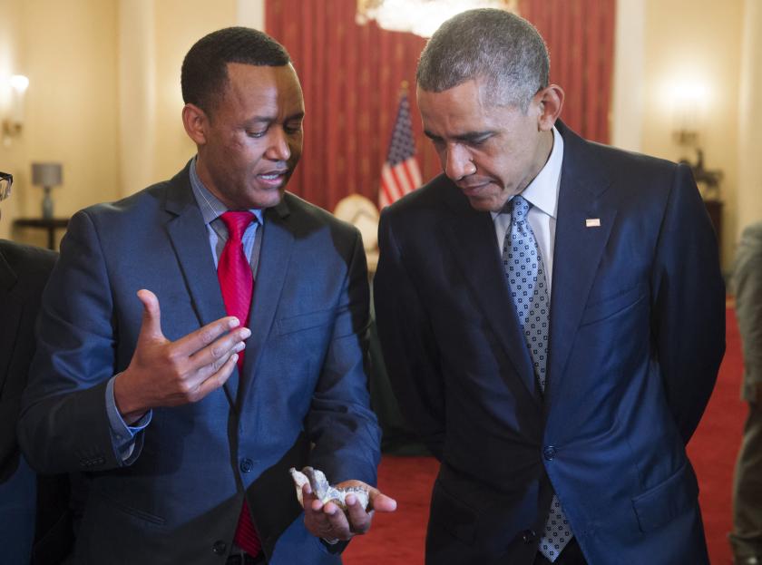 US President Barack Obama (R) looks at a bone fragment from "Lucy" who was estimated to have lived 3.2 million years ago, held by Dr. Zeresenay Alemseged Lemseged (L), head of the California Academy of Sciences, prior to a State Dinner at the National Palace in Addis Ababa, July 27, 2015. US President Barack Obama praised key African ally Ethiopia for its fight against Shebab militants in Somalia, but also challenged Addis Ababa on its democratic record. Obama is on the first-ever trip by a US president to Africa's second most populous nation, a close strategic partner for Washington credited for beating back the Al-Qaeda-affiliated Islamists but a country also much criticised for its rights record. AFP PHOTO / SAUL LOEB SAUL LOEB / AFP US President Barack Obama (R) looks at a bone fragment from "Lucy" who was estimated to have lived 3.2 million years ago, held by Dr. Zeresenay Alemseged Lemseged (L), head of the California Academy of Sciences, prior to a State Dinner at the National Palace in Addis Ababa, July 27, 2015. US President Barack Obama praised key African ally Ethiopia for its fight against Shebab militants in Somalia, but also challenged Addis Ababa on its democratic record. Obama is on the first-ever trip by a US president to