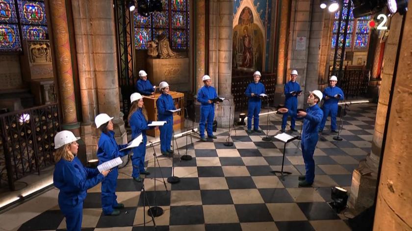 This video frame grab from Images France Televisions shows musicians of the Maitrise Notre-Dame de Paris performing inside the Notre-Dame de Paris Cathedral in Paris on Christmas Eve, December 24, 2020, for the first time since the Cathedral was partially destroyed in a fire on April 15, 2019. STR / IMAGES FRANCE TELEVISIONS / AFP noel 2020 concert