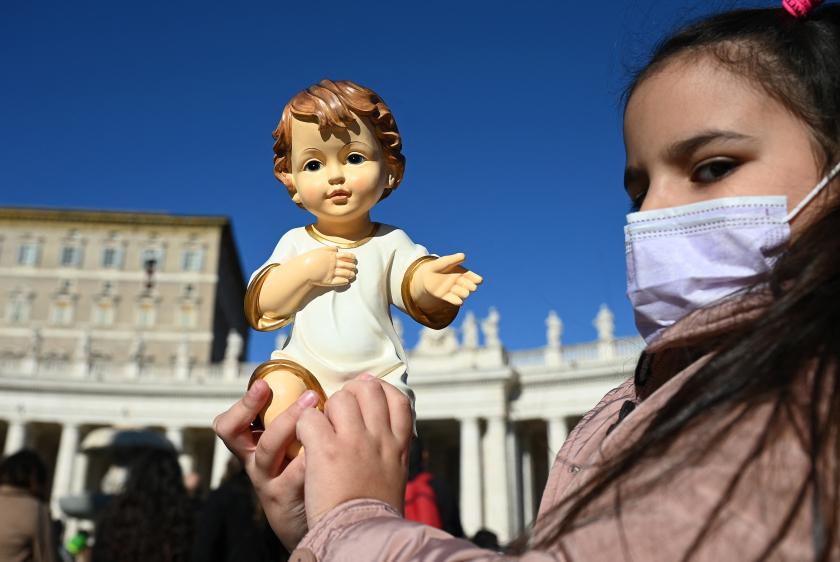 A child holds up a Nativity Scene figurine of baby Jesus during the traditional blessing of figurines as part of the pope's Sunday Angelus prayer before Christmas in Saint Peter's square at the Vatican on December 12, 2021. Vincenzo PINTO / AFP A child holds up a Nativity Scene figurine of baby Jesus during the traditional blessing of figurines as part of the pope's Sunday Angelus prayer before Christmas in Saint Peter's square at the Vatican on December 12, 2021.