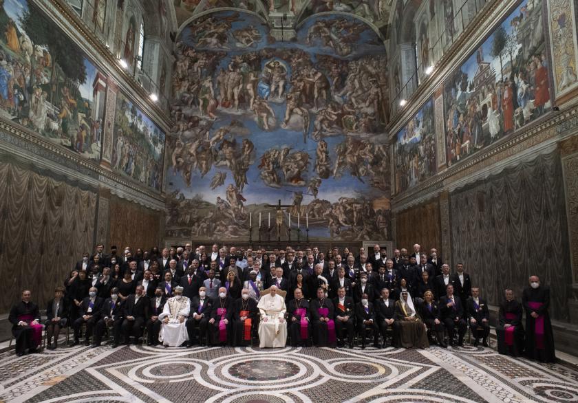 This handout photo taken on January 10, 2022 and released by the Vatican press office, the Vatican Media, shows Pope Francis posing with the diplomatic corps in the Sistine Chapel after his new year greetings at the Vatican on January 10, 2022. This handout photo taken on January 10, 2022 and released by the Vatican press office, the Vatican Media, shows Pope Francis posing with the diplomatic corps in the Sistine Chapel