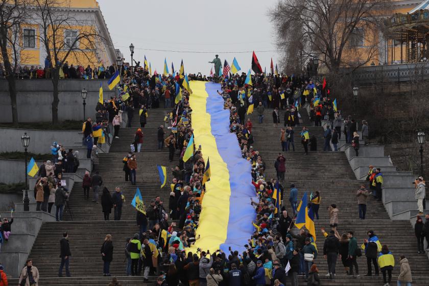 Protesters carry a giant Ukrainian flag during a rally to show unity and support of Ukrainian integrity, amid soaring tensions with Russia, in the southern Ukrainian city of Odessa, on February 20, 2022. Ukraine and Russia both on February 20 called for intensified diplomatic efforts to avert all-out war, but blamed each other for a sharp escalation in shelling on Kyiv's frontline with Moscow-backed separatists. Oleksandr GIMANOV / AFP Protesters carry a giant Ukrainian flag during a rally to show unity and support of Ukrainian integrity, amid soaring tensions with Russia, in the southern Ukrainian city of Odessa, on February 20, 2022. Ukraine and Russia both on February 20 called for intensified diplomatic efforts to avert all-out war, but blamed each other for a sharp escalation in shelling on Kyiv's frontline with Moscow-backed separatists.