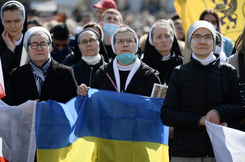 Nuns hold the Ukranian flag as Pope Francis delivers the Sunday Angelus prayer from the window of his study overlooking St Peter's Square at the Vatican on March 6, 2022. Filippo MONTEFORTE / AFP Nuns hold the Ukranian flag as Pope Francis delivers the Sunday Angelus prayer from the window of his study overlooking St Peter's Square at the Vatican on March 6, 2022.