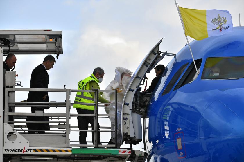 A gust of wind lifts Pope Francis' cassock (C) as he boards his plane from a lift designed for the boarding and off boarding of reduced mobility passengers, on April 02, 2022 at Rome's Fiumicino airport, as he departs for a two-day trip to Malta. Pope Francis heads for a two-day trip to Catholic-majority Malta where he will again highlight the plight of migrants, as the Ukraine war sends a stream of refugees across Europe. Tiziana FABI / AFP A gust of wind lifts Pope Francis' cassock (C) as he boards his plane from a lift designed for the boarding and off boarding of reduced mobility passengers, on April 02, 2022 at Rome's Fiumicino airport, as he departs for a two-day trip to Malta. Pope Francis heads for a two-day trip to Catholic-majority Malta where he will again highlight the plight of migrants, as the Ukraine war sends a stream of refugees across Europe.