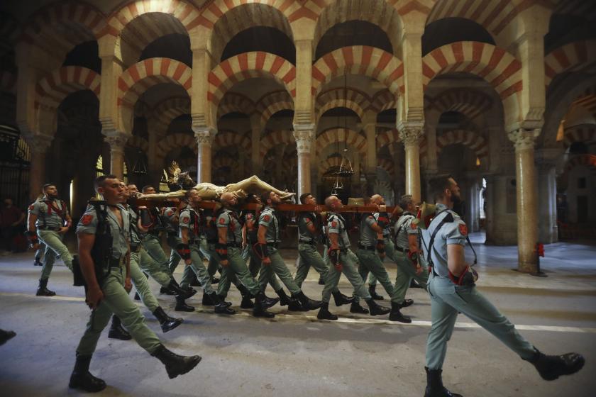 Great Captain Third's legionnaires carry the Christ of Charity during the Via Crucis procession on Good Friday inside the Mosque of Cordoba, southern Spain, 15 April 2022. EPA/SALAS Great Captain Third's legionnaires carry the Christ of Charity during the Via Crucis procession on Good Friday inside the Mosque of Cordoba, southern Spain, 15 April 2022.