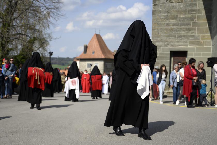 Veiled women known as 'Les Pleureuses,' or mourning women, whose heads are covered with black cloth to commemorate the Passion and Crucifiction of Jesus follow a cross bearer after the Good Friday mass at the Collegiale de Notre-Dame de l'Assomption church in Romont, Fribourg, Switzerland, 15 April 2022. EPA/ANTHONY ANEX Veiled women known as 'Les Pleureuses,' or mourning women, whose heads are covered with black cloth to commemorate the Passion and Crucifiction of Jesus follow a cross bearer after the Good Friday mass at the Collegiale de Notre-Dame de l'Assomption church in Romont, Fribourg, Switzerland, 15 April 2022.