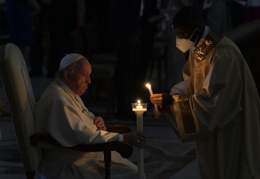 Pope Francis (L) holds a candle as he attends the Easter Vigil Mass in Saint Peter's Basilica at the Vatican, 16 April 2022. EPA/CLAUDIO PERI Pope Francis (L) holds a candle as he attends the Easter Vigil Mass in Saint Peter's Basilica at the Vatican, 16 April 2022.
