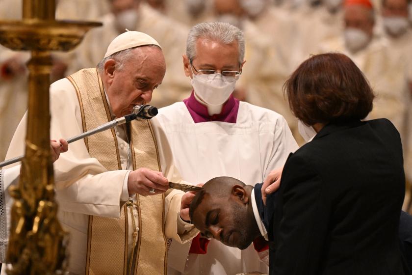 A catechumen from Cuba (C) receives Baptism from Pope Francis during the Easter Vigil mass on April 16, 2022 at St. Peter's Basilica in The Vatican. Tiziana FABI / AFP A catechumen from Cuba (C) receives Baptism from Pope Francis during the Easter Vigil mass on April 16, 2022 at St. Peter's Basilica in The Vatican.