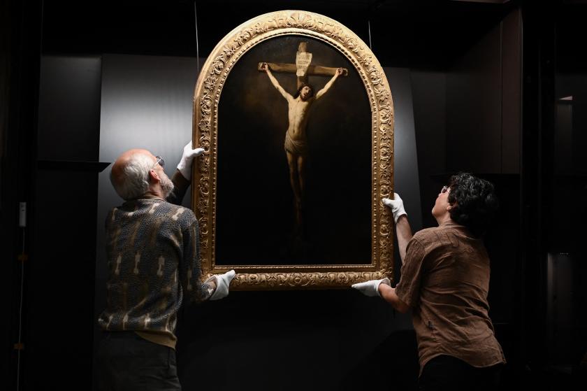 French painting restorers take measurements of a 1631 oil on canvas painting by Rembrandt, "Christ on the Cross" in the Saint-Andre Cathedral in Bordeaux on May 24, 2022, south-western France, before the painting is transported back to the Saint-Vincent church in the French town of Le Mas-d'Agenais. Philippe LOPEZ / AFP French painting restorers take measurements of a 1631 oil on canvas painting by Rembrandt, "Christ on the Cross" in the Saint-Andre Cathedral in Bordeaux on May 24, 2022, south-western France, before the painting is transported back to the Saint-Vincent church in the French town of Le Mas-d'Agenais.