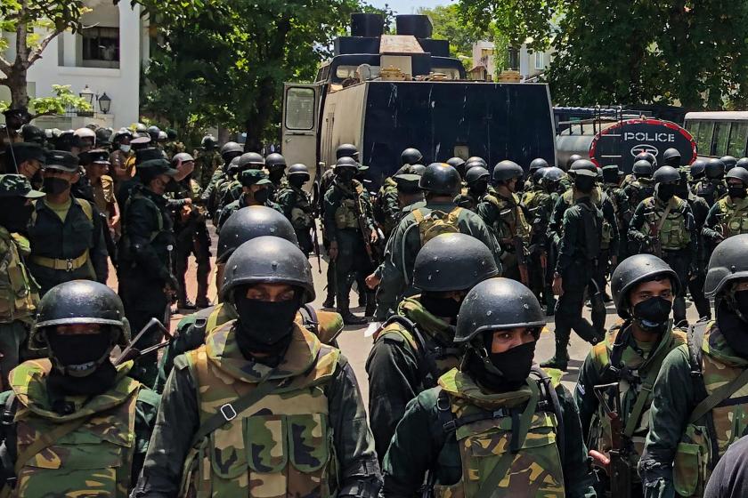 Army soldiers stand guard during an anti-government protest by demonstrators outside the office of Sri Lanka's prime minister in Colombo on July 13, 2022. Sri Lankan police fire tear gas to hold back thousands of demonstrators mobbing the premier's office in Colombo on July 13 Army soldiers stand guard during an anti-government protest by demonstrators outside the office of Sri Lanka's prime minister in Colombo on July 13, 2022. Sri Lankan police fire tear gas to hold back thousands of demonstrators mobbing the premier's office in Colombo on July 13, AFP reporters at the scene saw.